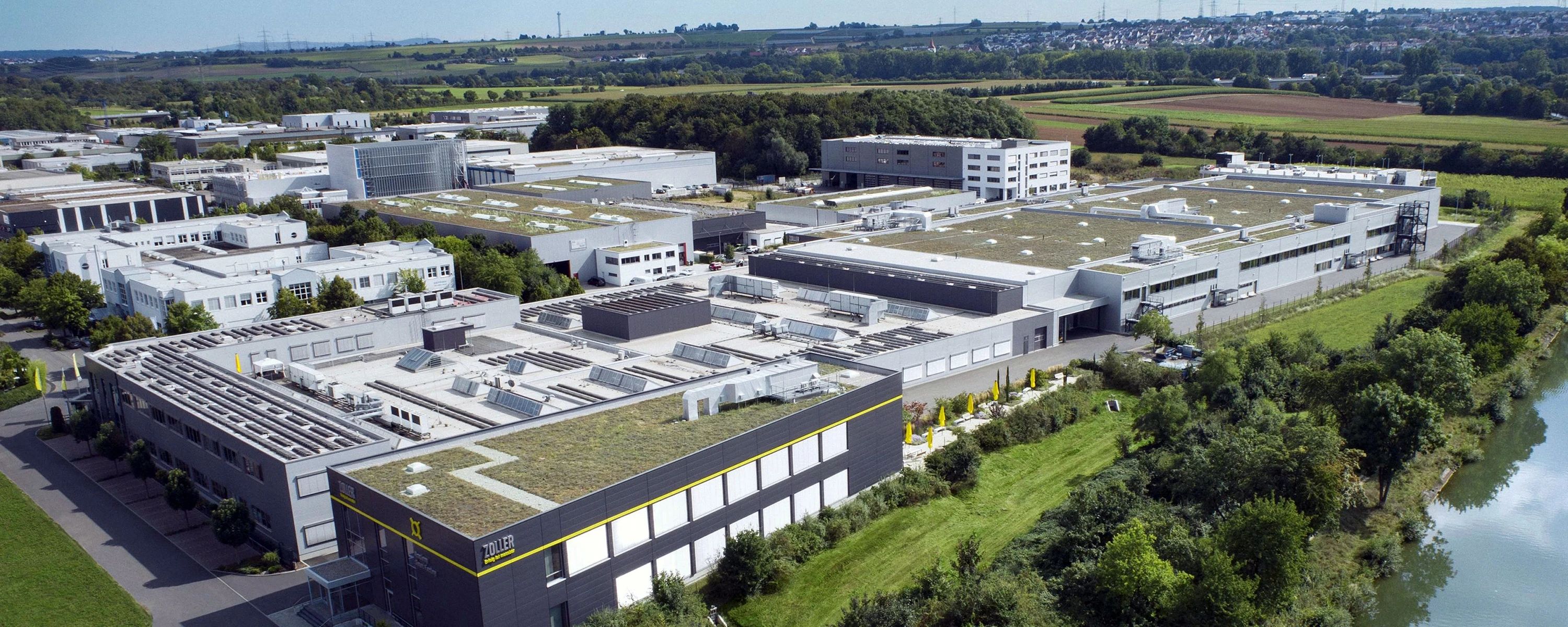 Luftaufnahme des e‑zoller Firmenhauptsitzes mit modernen Gebäuden und grünen Dachflächen – nachhaltige Unternehmenszentrale für Präzisionsmesstechnik und Digitalisierungslösungen.