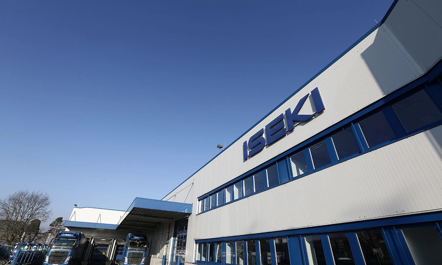 Firmengebäude von Iseki – moderne Industriehalle mit Unternehmenslogo, Standort des Spezialisten für Kommunal‑ und Landtechnikmaschinen.